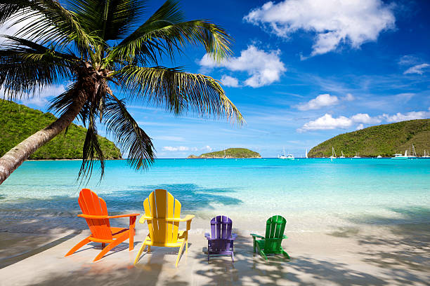 colorful andirondack chairs at a Caribbean beach colorful andirondack chairs for a family vacation at a Caribbean beachview images from the same series: st john's plant stock pictures, royalty-free photos & images