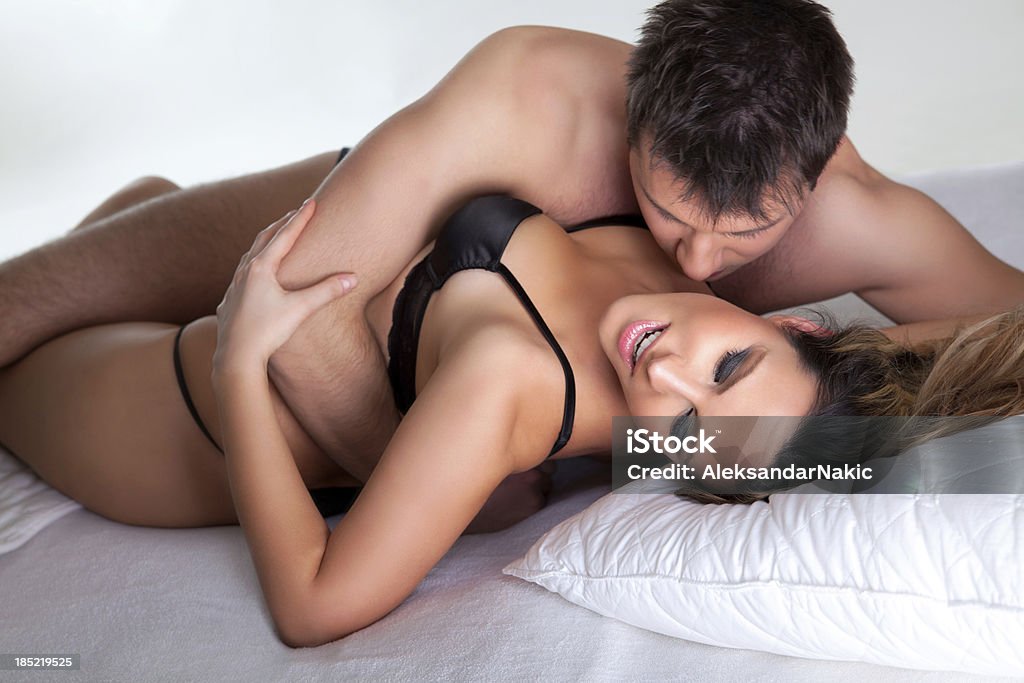 Couple in a bedroom Passionate couple making love Men Stock Photo