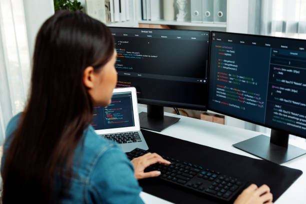 istock Young Asian in IT creating with typing online information on pc. Stratagem. 1852198383