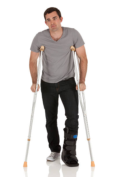 istock Injured man walking with the help of crutches 185219894