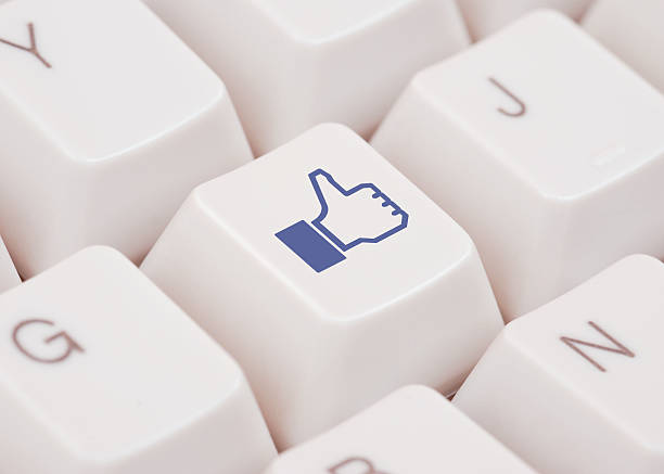 Thumbs Up icon on white computer keyboard