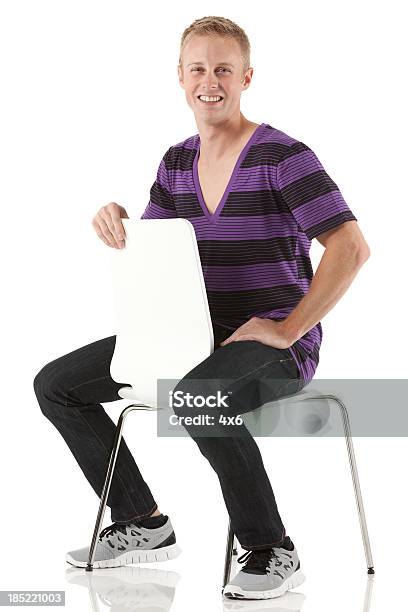 Man Sitting On A Chair Stock Photo - Download Image Now - 20-29 Years, Adult, Adults Only