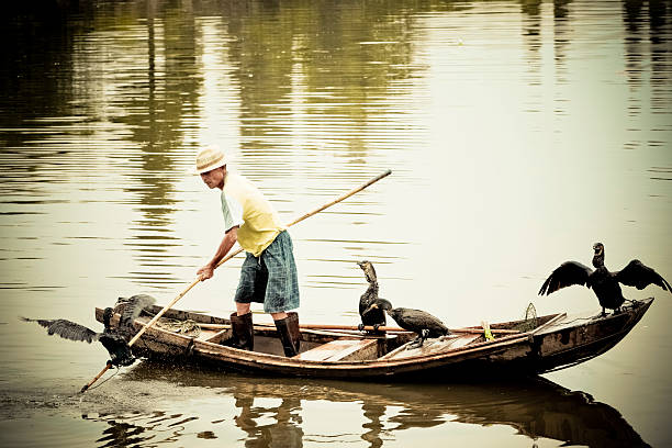 Small fishing boat floating on the lake against mountains. Lang Co, Vietnam