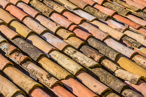 Old roof tiles in terracotta, full frame.