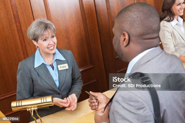 Friendly Front Desk Lady Helping Hotel Guest Stock Photo - Download Image Now - African Ethnicity, Hotel Reception, Hotel