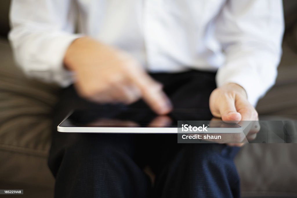 Man Working on Digital Tablet A man working on a digital tablet. Business Stock Photo