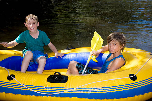 río boys - child inflatable raft lake family fotografías e imágenes de stock