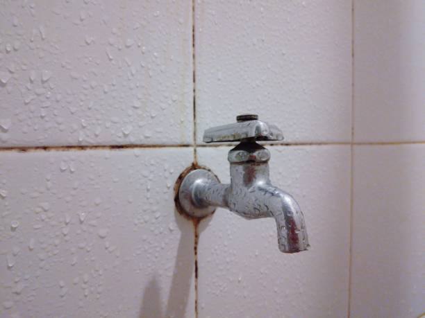 istock A faucet mounted on the brick wall in the bathroom. 1852221523