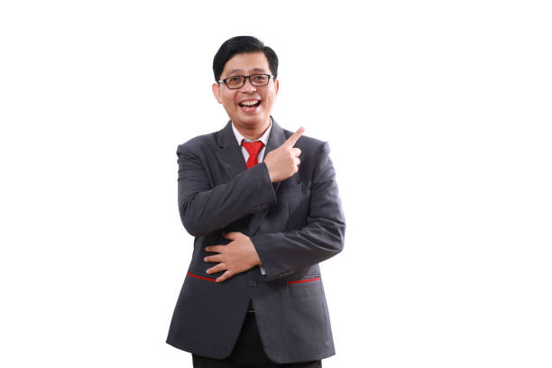 istock Happy asian businessman standing while pointing sideways. Isolated on white 1852222805
