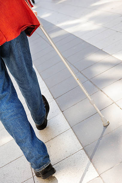 istock Person with cane on tiled sidewalk 185222525