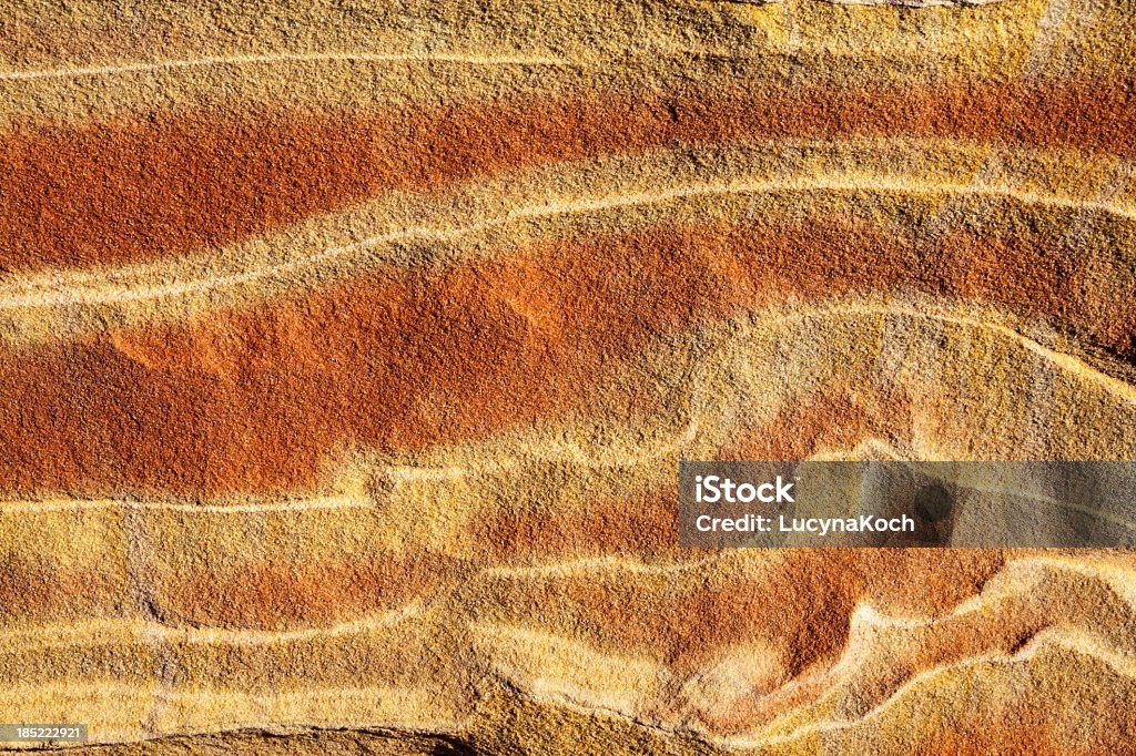 Sandstone background in red and yellow Beautifully red - orange colored rock with striped patterns (The Wave, Vermillion Cliffs). Sand Stock Photo