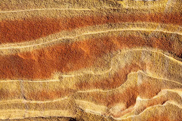 Beautifully red - orange colored rock with striped patterns (The Wave, Vermillion Cliffs).