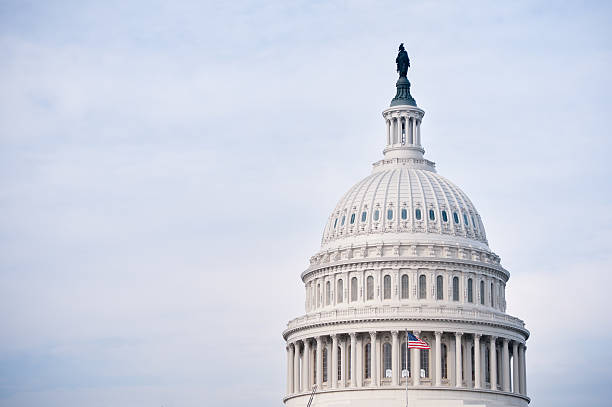 The United States Capitol in Washington DC "The United States Capitol in Washington DC, USA. The Capitol is the home of the US Congress, the Senate and the House of Representatives. The American flag waving on the roof. Close-up shot of the dome." dome stock pictures, royalty-free photos & images