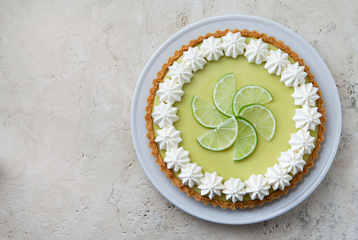 Key lime pie on a marble table.