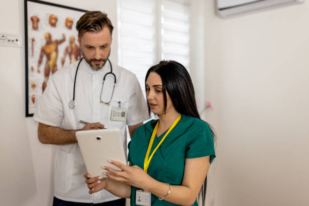 Dynamic Duo of Doctors Analyzing X-Ray Images on Digital Tablet