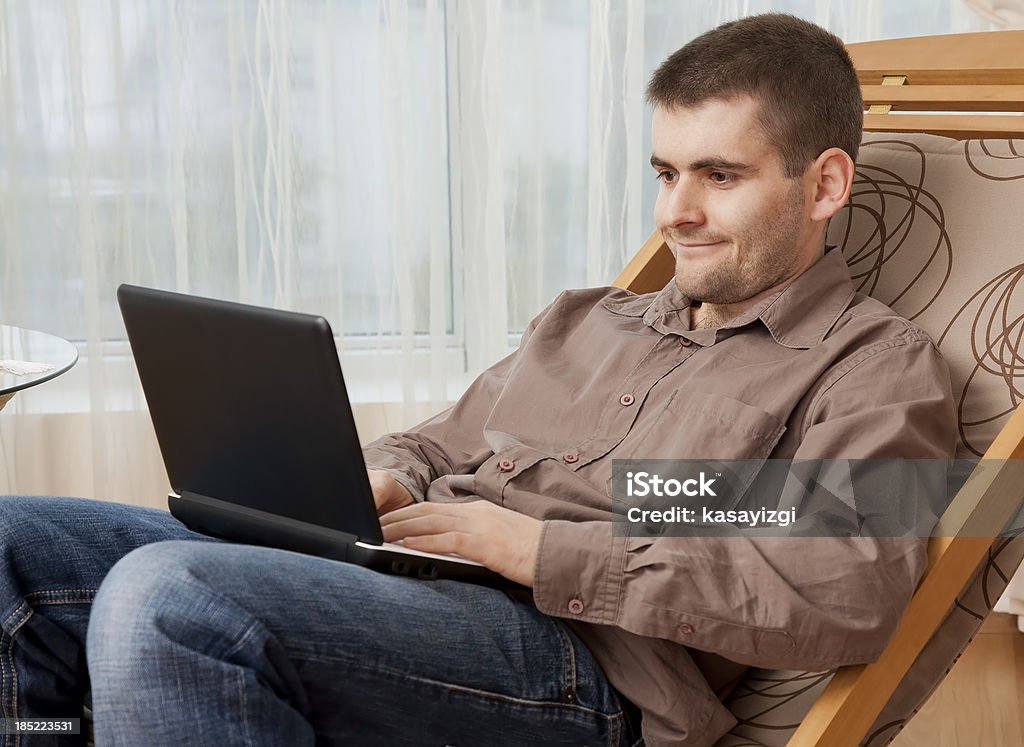 Working in the living room, smiling "Working in the living room, smiling" Adult Stock Photo