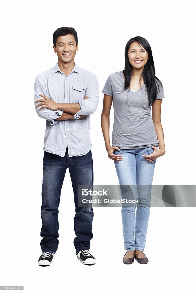 Young, trendy and fun Young Asian couple standing smiling while isolated on white Asian and Indian Ethnicities Stock Photo
