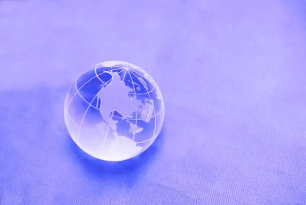 Photo of glass globe on purple background