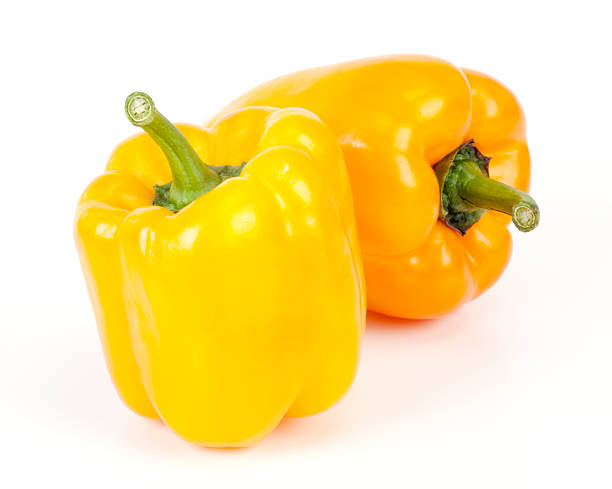 istock 2 bright yellow sweet peppers on white background 185223824