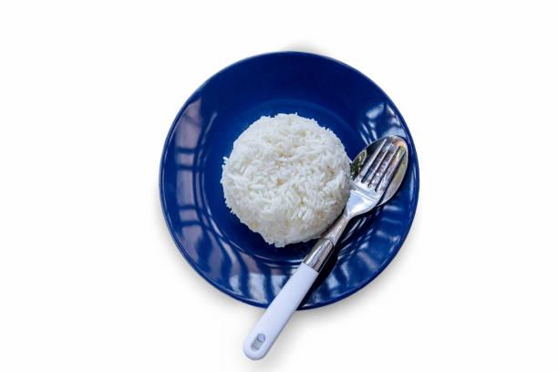 Cooked basmati rice served in a ceramic bowl or plate on white background.