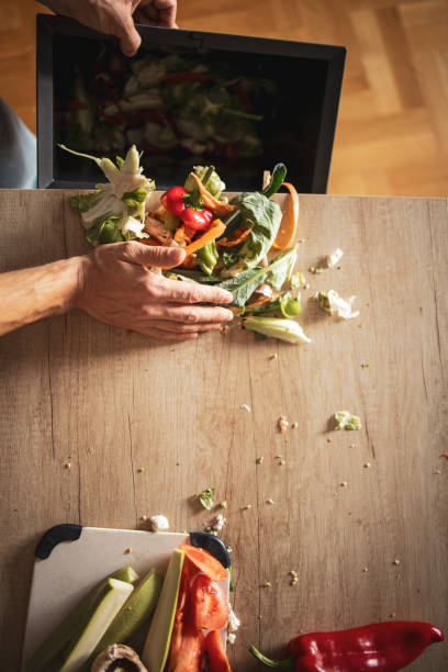istock Man cooking vegetable meal at home. He is chopping vegetables and preparing compost 1852239084