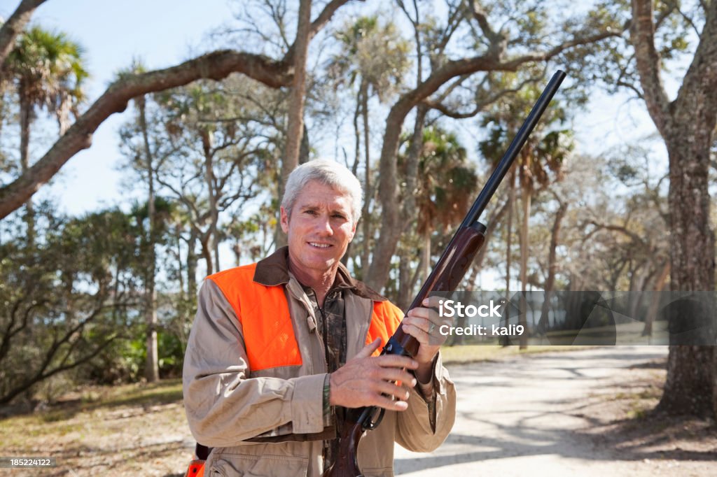 Hunter Man (40s) hunting for quail or pheasant. Hunter Stock Photo