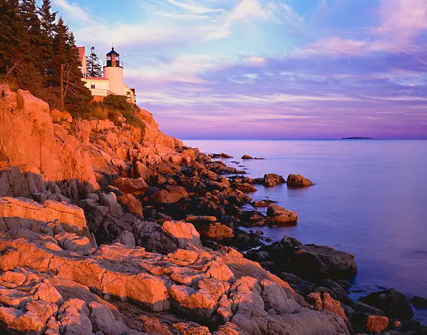 Sunrise with rocky cliffs at Bass Harbor Lighthouse Acadia National Park, Maine