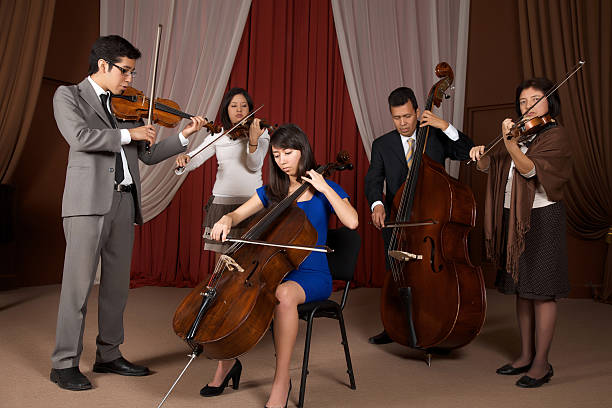 Five family members playing a strings concert, Cello, violin, viola, bass