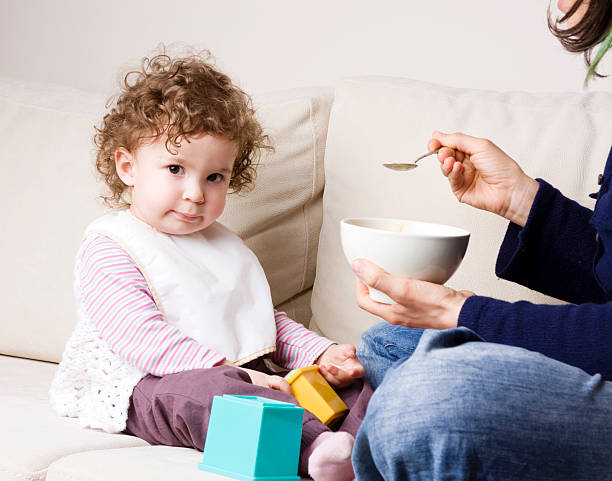 istock Mother feeding her baby 185224365