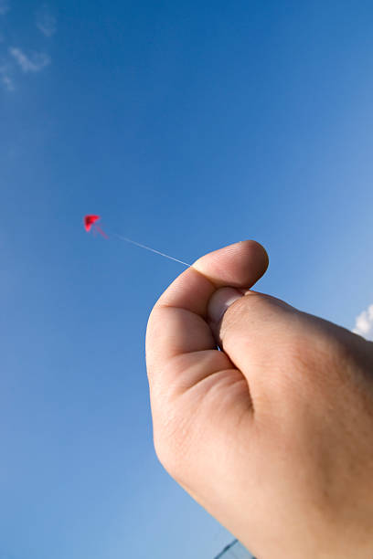 istock close-up of womans hands flying kite 185224460