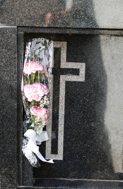 istock Plastic flowers on a grave in a cemetery 1852247096