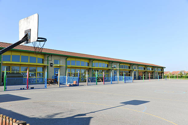 bâtiment de l'école et terrain de jeu - schoolyard photos et images de collection