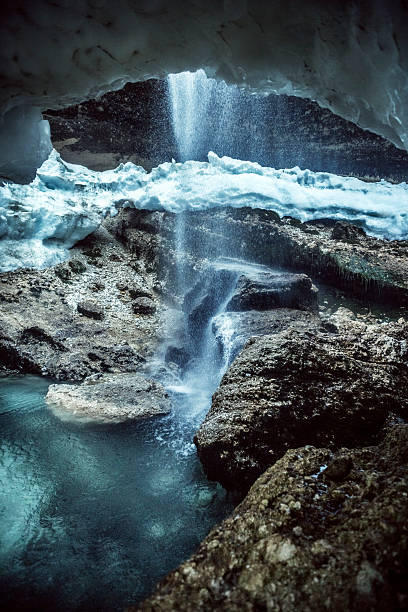 istock Alpine waterfall shot from snow cave 185224759