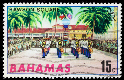 A 1970 Bahamas postage stamp with an illustration of marching band performing before a crowd on Rawson Square in downtown Nassau, Bahamas.