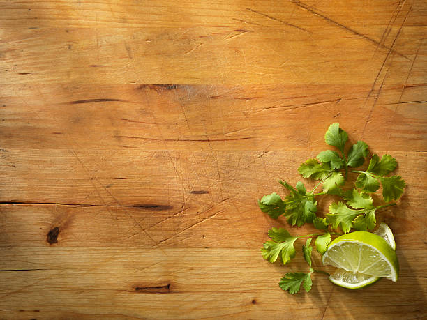 Limes with Fresh Cilantro Limes with Fresh Cilantro-Photographed on Hasselblad H3D2-39mb Camera fresh cilantro stock pictures, royalty-free photos & images