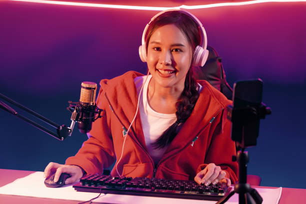 istock Host channel smiling Asian wearing headphone recording on phone. Stratagem. 1852252943