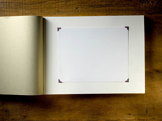 Blank photo album Blank traditional photo album on a wooden background. scrapbook stock pictures, royalty-free photos & images