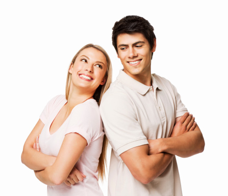 A man and woman are standing back to back and smiling at each other.  Horizontal shot. Isolated on White