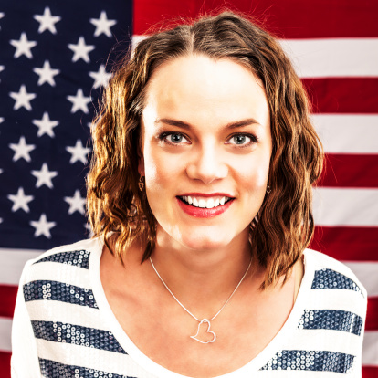 Happy woman infront of an american flag