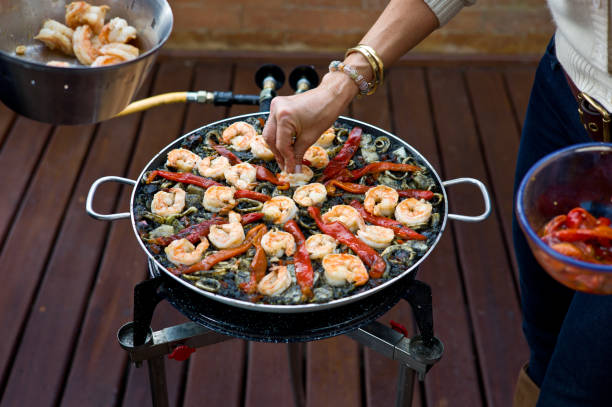istock Making Black Paella: Decorating with Grilled Shrimp and Peppers 185226026
