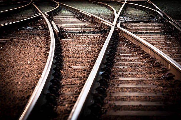 поезд линии переход - railroad track direction choice transportation стоковые фото и изображения