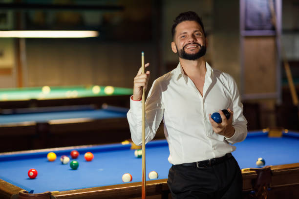 istock Billiard player at billard table or snooker american billiards pool sport game 1852265694