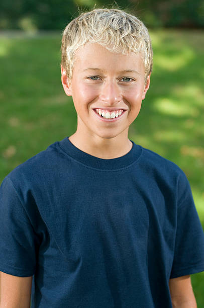 istock Young blonde boy in blue shirt smiling 185226939