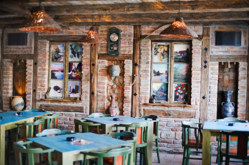 Old fashioned restaurant in absense of guests. Enterior design including wall paintings by Dejan Urosevic (property release included).