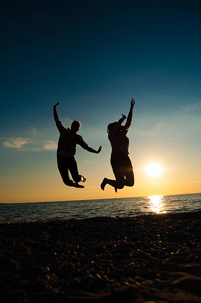 istock Girls Jumping on Beach 185227156