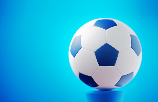 Soccer ball on blue background. Horizontal composition.