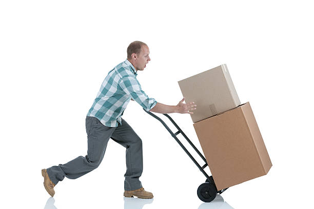 istock Man carrying cardboard boxes in a warehouse 185227511