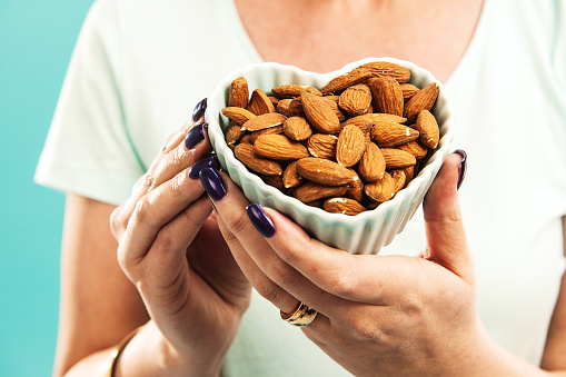 Woman with bowl of almonds
