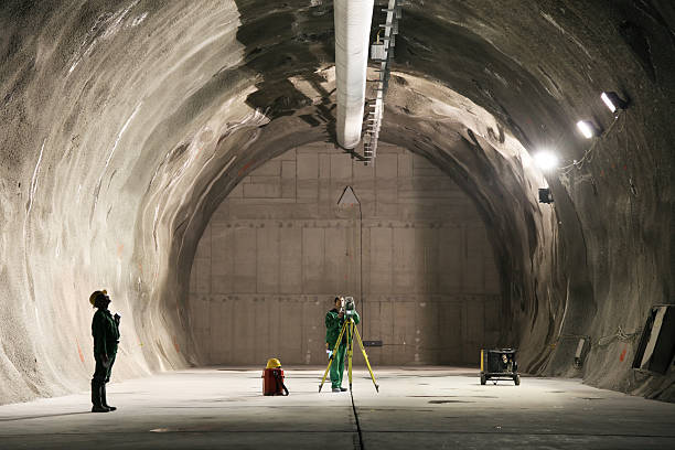 Professional underground workers A miner and a surveyor working underground. geology stock pictures, royalty-free photos & images