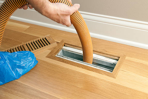 Vacuum Hose Cleaning Floor Vent and Duct stock photo